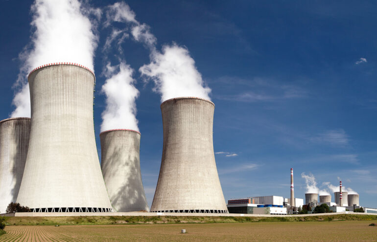 A depiction of a nuclear power plant and its cooling towers.